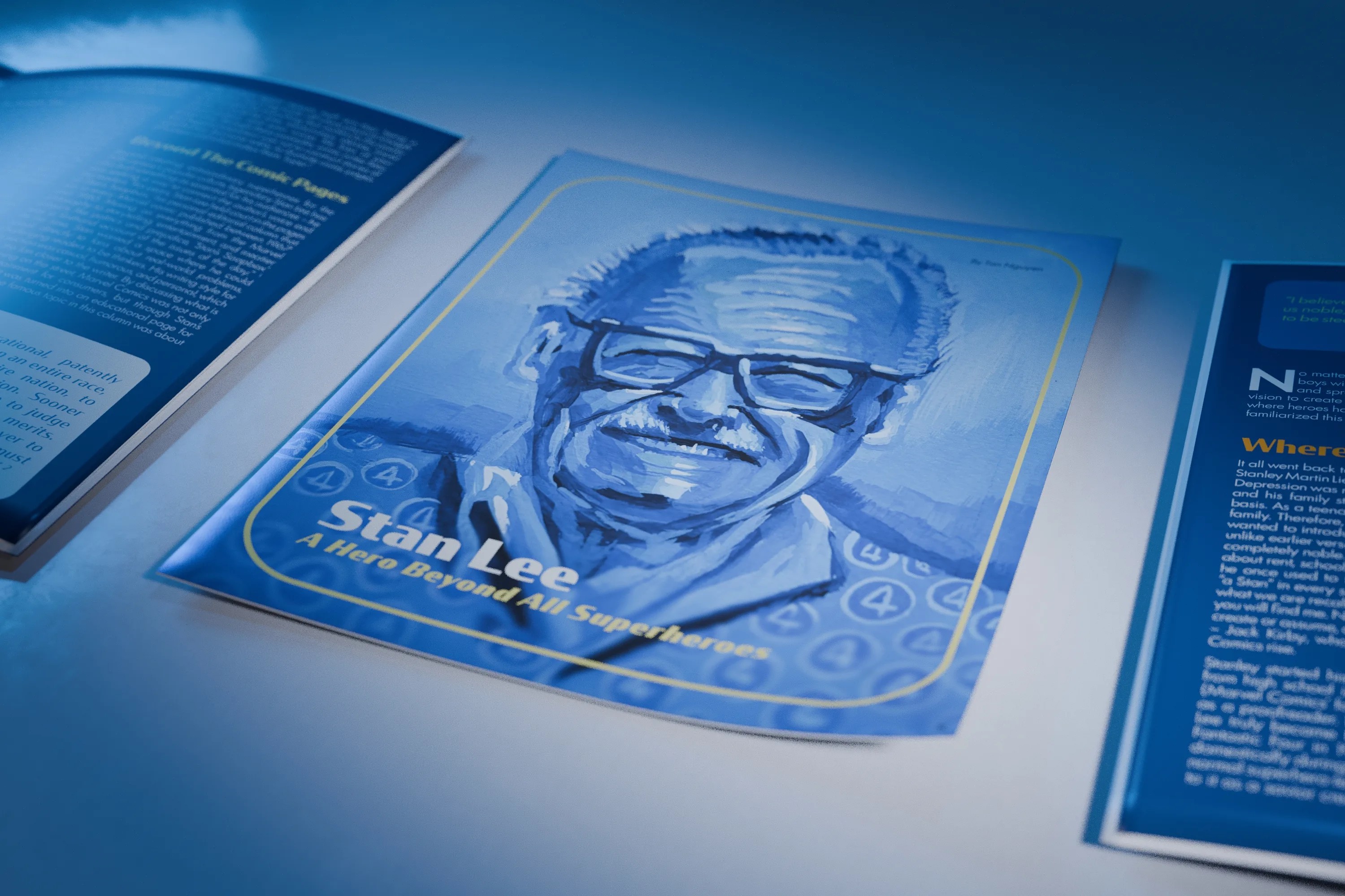 Angled close view of the paper's cover, the blue painted portrait of Stan Lee and its title, with a spread headed Where It All Began to the right.