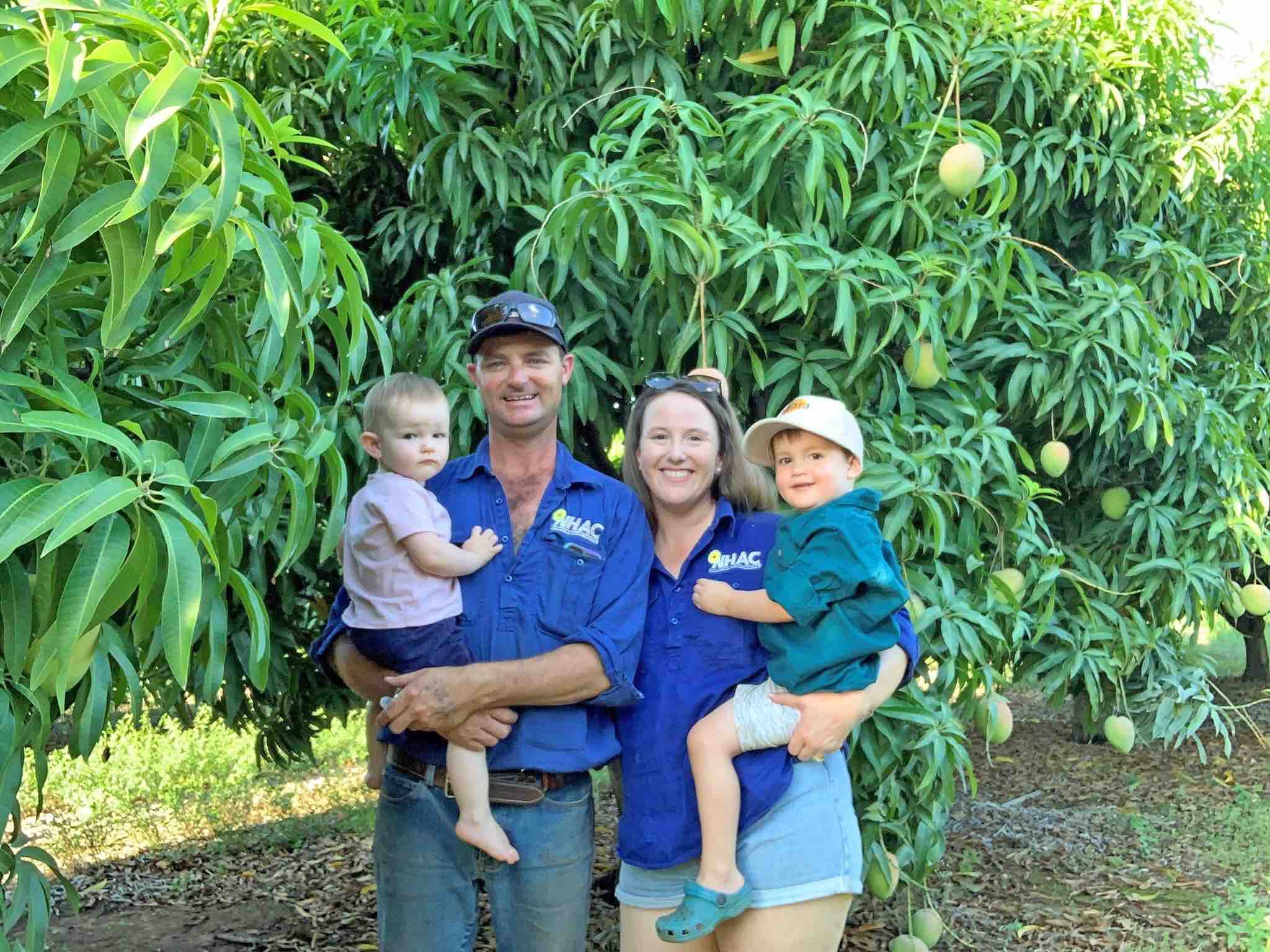 Nick and Whitney Ormsby with their children in a mango orchard at Razor Rock Farm, Katherine NT