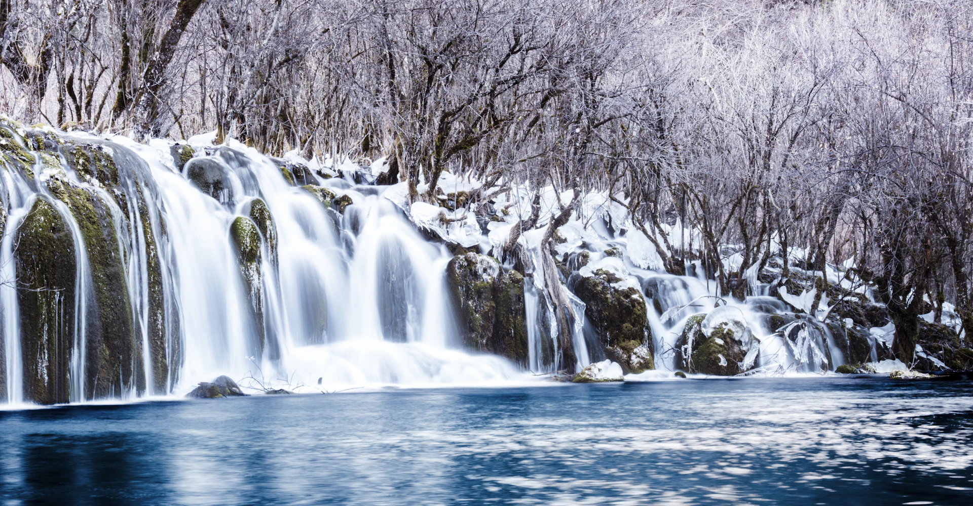 Wide waterfall cascading into a pool, Jiuzhaigou National Park