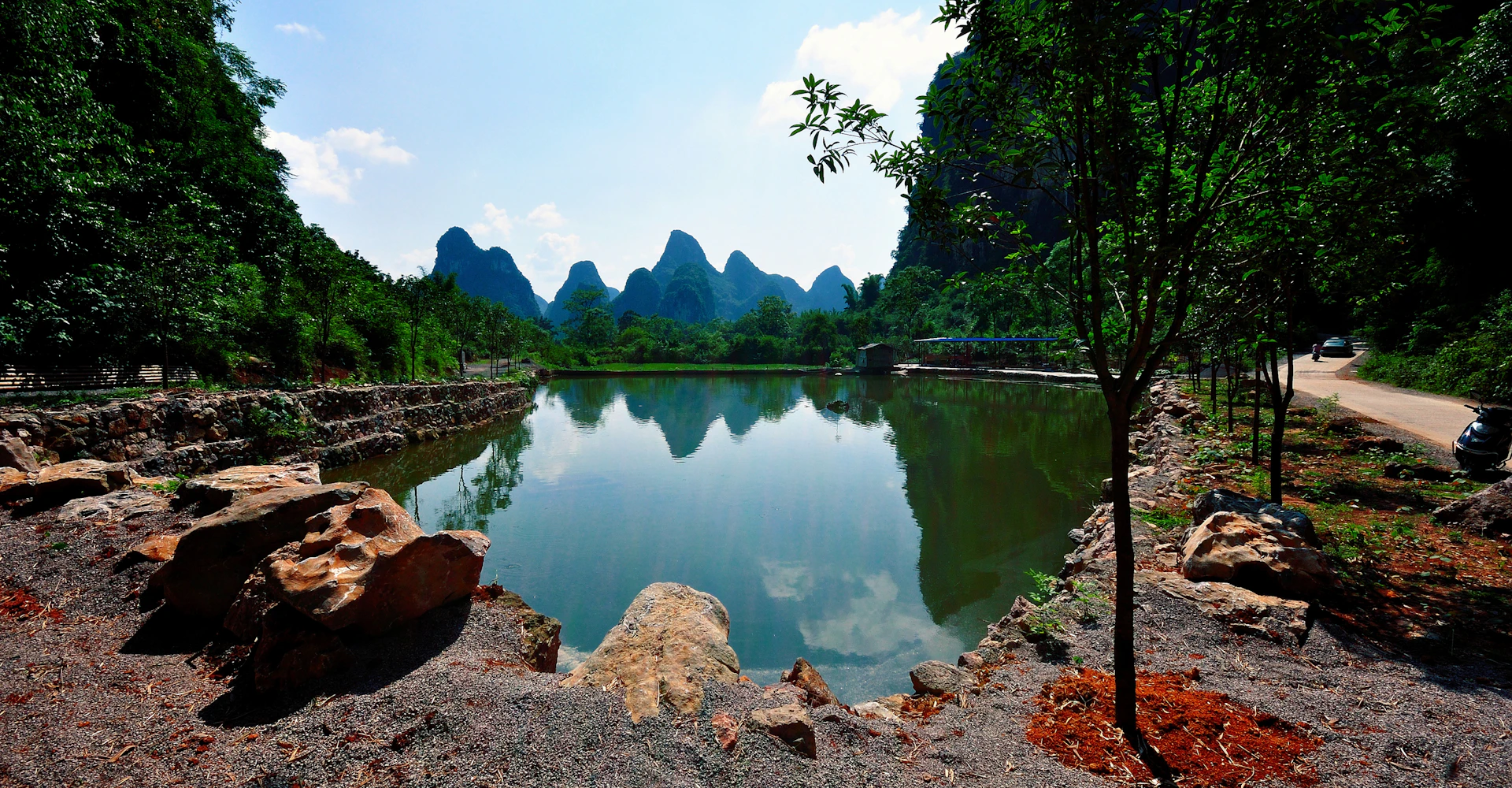 Lake ringed by karst mountains and trees