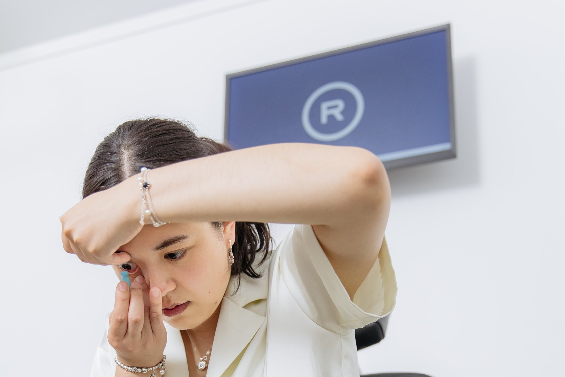Woman inserting a specialty contact lens at Rose Optometry in Hamilton