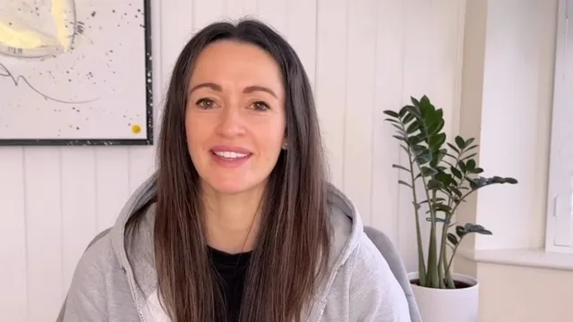 Katie sat in front of camera smiling