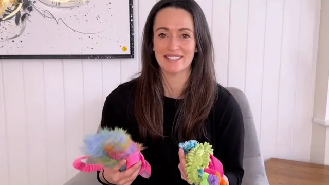 Katie holding up two dog toys
