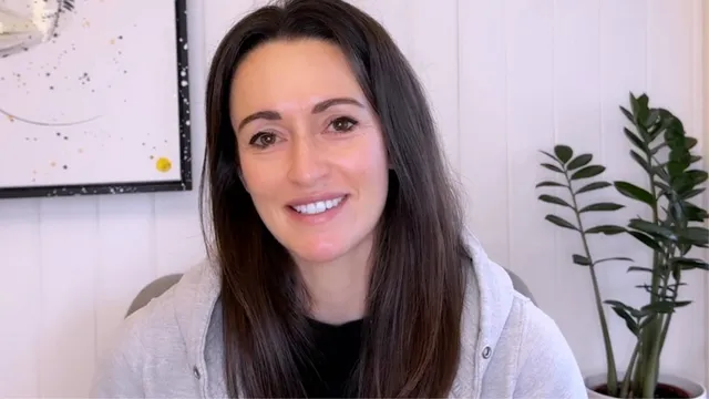 Katie smiling in front of camera