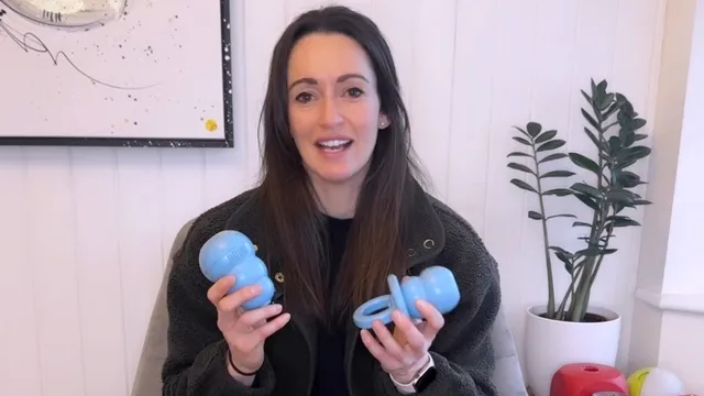 Katie holding two Kong toys
