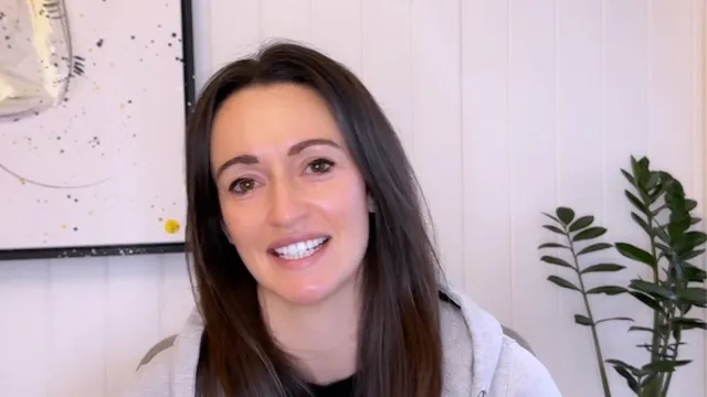 Katie smiling in front of camera