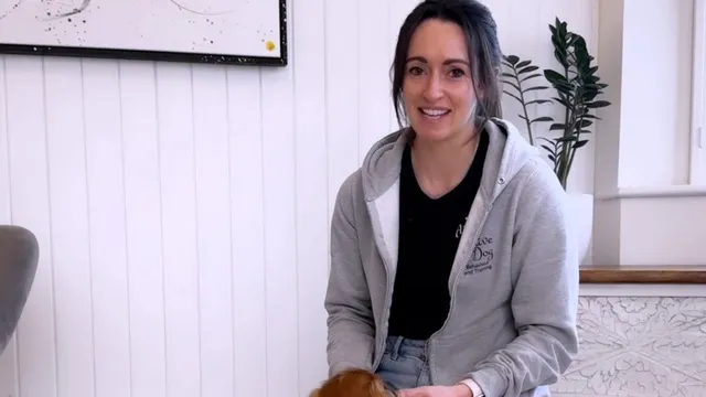 Katie demonstrating how to get a dog to sit
