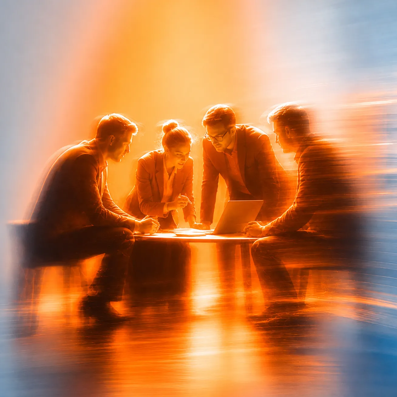 A business team of four people, three men and one woman, are gathered around a low table, focusing on a laptop and documents in a warmly lit room with an orange and blue gradient background.