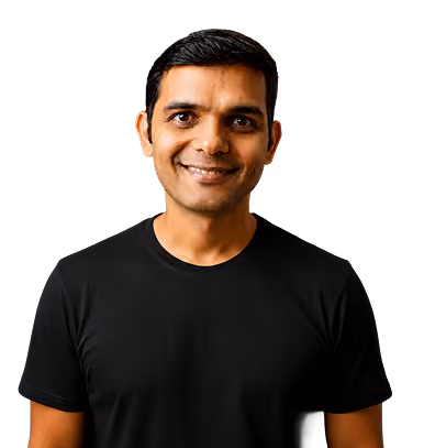 Smiling man with short black hair wearing a black t-shirt against a transparent background.