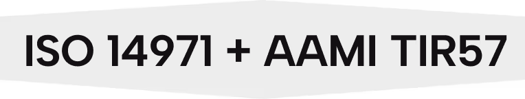 Text image showing 'ISO 14971 + AAMI TIR57' in dark gray letters on a black background, indicating standards related to risk management for medical devices.