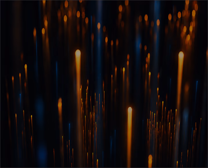Dark background with vertical streaks of glowing orange and blue light resembling fiber optic strands or light trails.