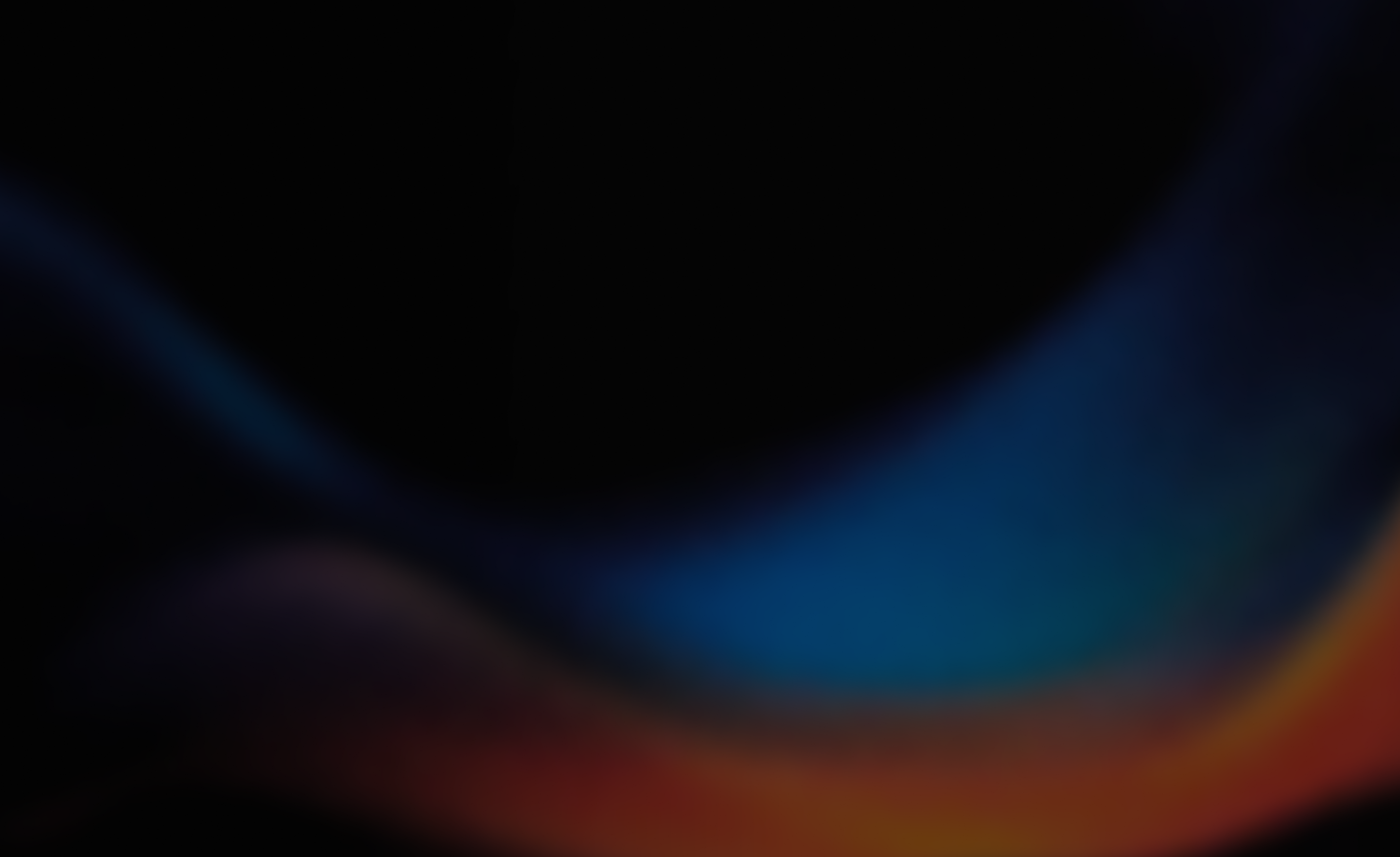 Abstract blurred background with dark tones and smooth gradient waves of blue, purple, and orange hues.
