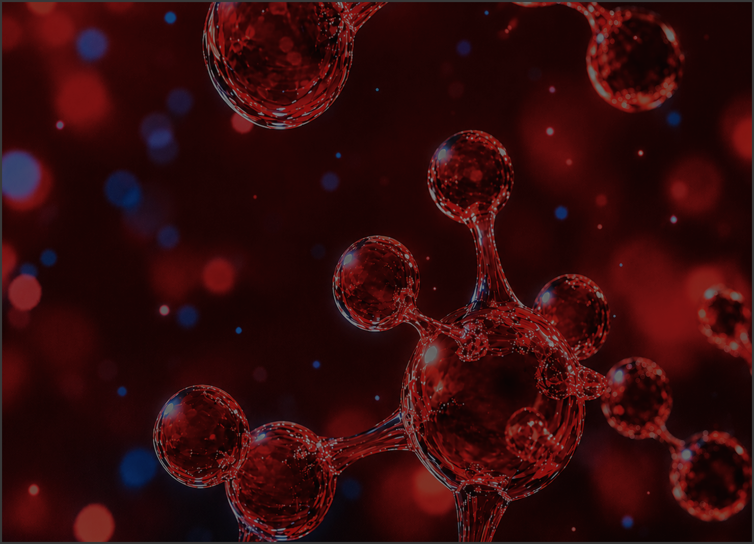 Red molecular or atomic structures resembling connected spheres with a glossy, glass-like appearance against a dark background with red and blue bokeh light effects.