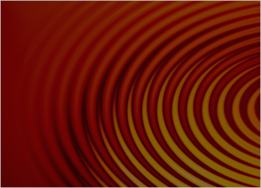 Close-up of concentric circular ripples spreading outward on a dark red and orange reflective surface.