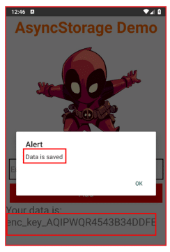 Mobile screen showing an AsyncStorage Demo app with a pop-up alert saying 'Data is saved' and an OK button, featuring a small Deadpool character above the alert and a displayed encrypted key below.