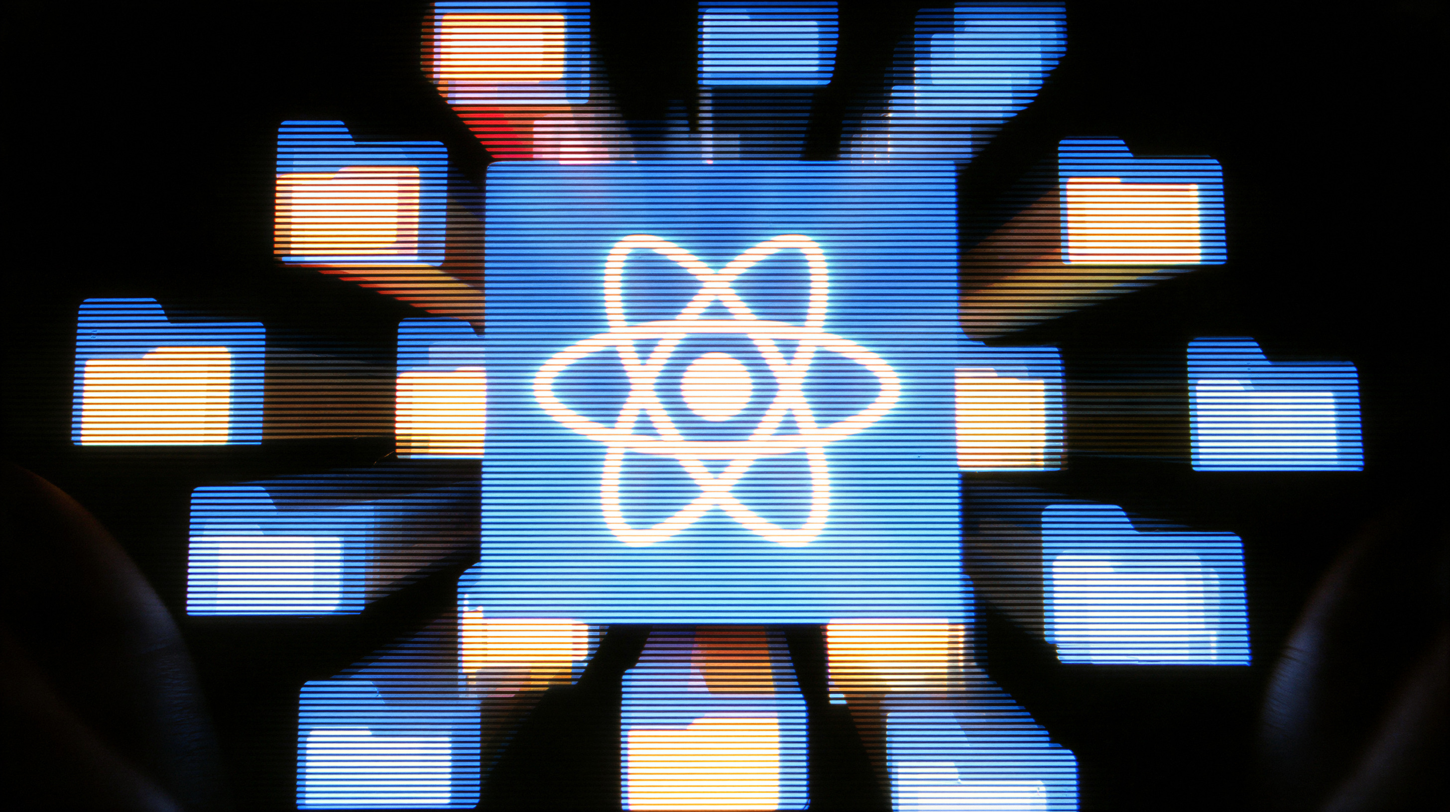 Glowing blue digital folder icons with one central folder featuring a white atomic symbol, arranged in a circular pattern on a dark background.
