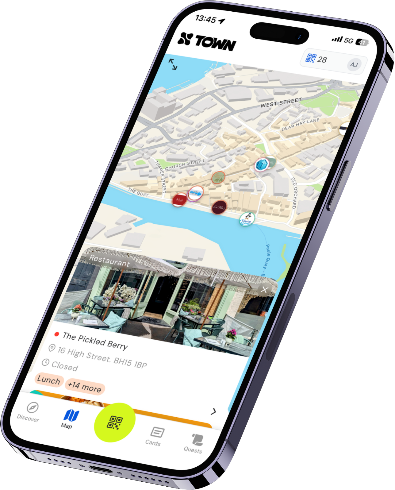Smartphone screen displaying a town map app with a highlighted restaurant called The Pickled Berry at 16 High Street, marked closed, showing a photo of an outdoor seating area, and navigation icons for Discover, Map, QR scanner, Cards, and Quests at the bottom.