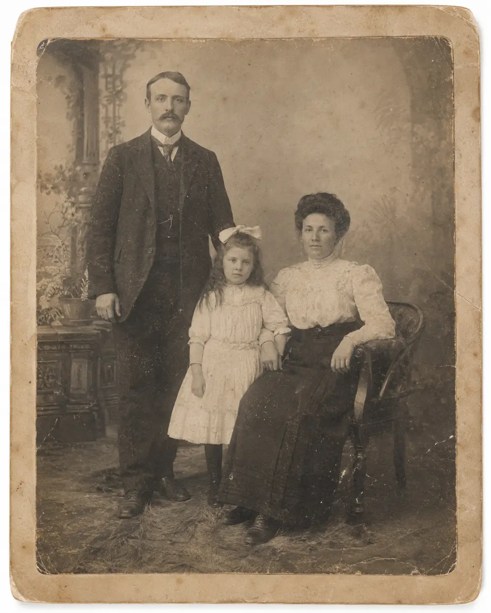 The same family portrait before restoration, worn and faded