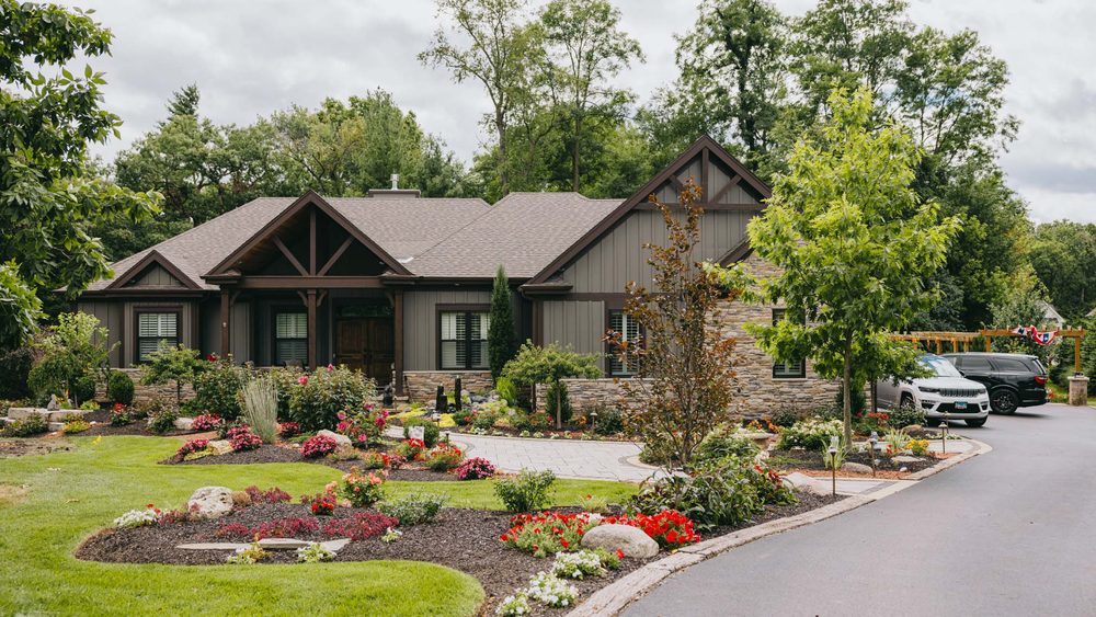 Landscaped home exterior with colourful flower beds and stone accents in St. Charles, Illinois.