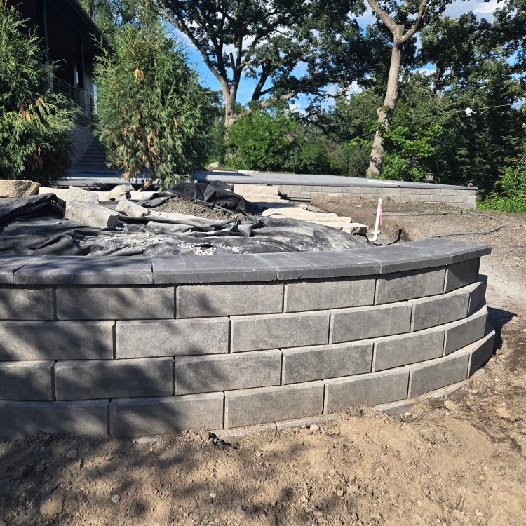 Completed tiered retaining wall installation at the Ranallo Residence in Elgin, Illinois, built by Custom Scapes & Designs from the custom landscape design process.