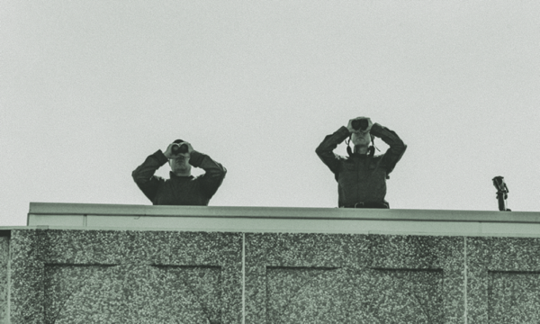 People looking out through binoculars, representing search for data leaks.