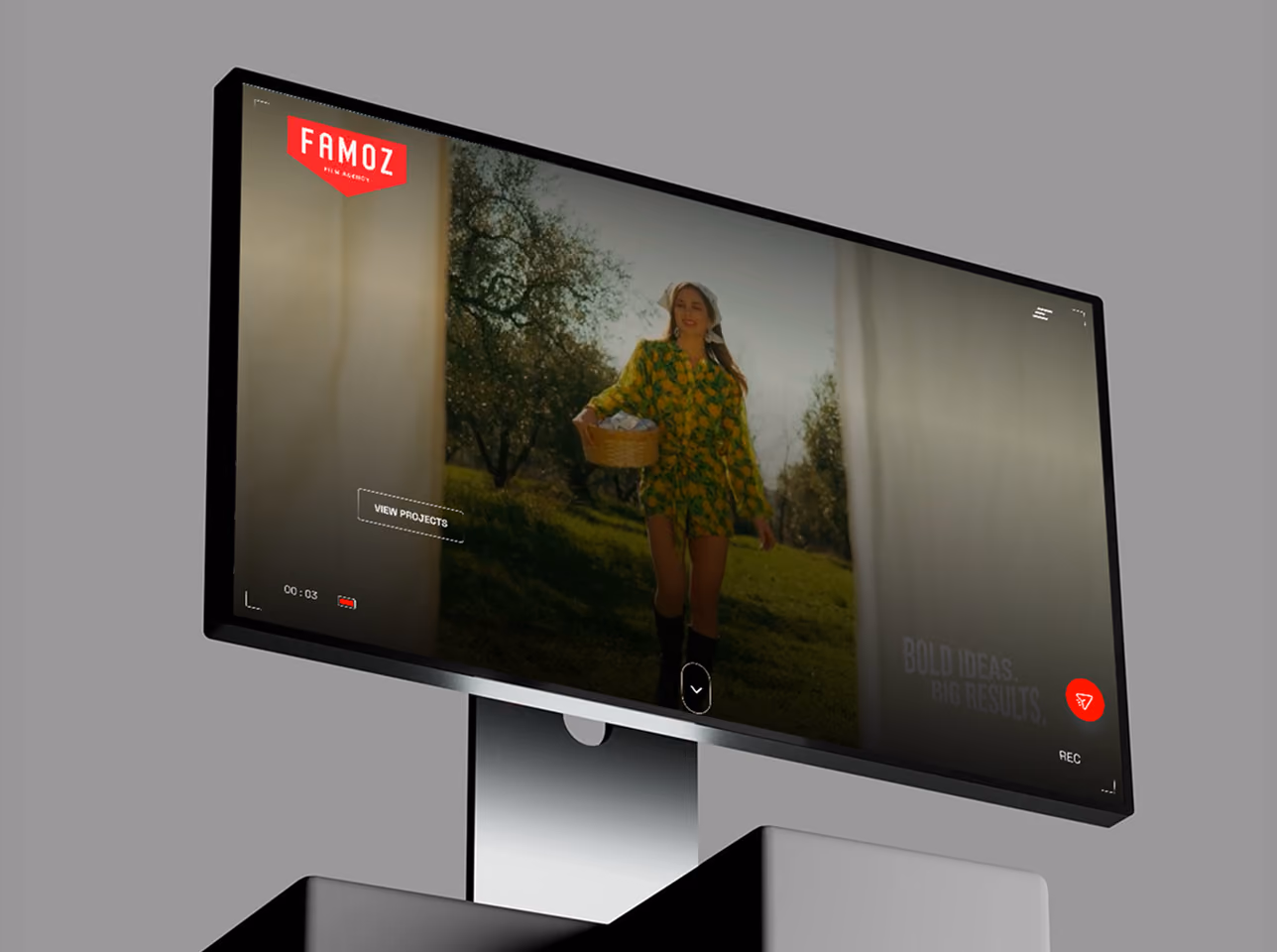 Computer monitor displaying a video of a woman in a yellow dress holding a basket outdoors.