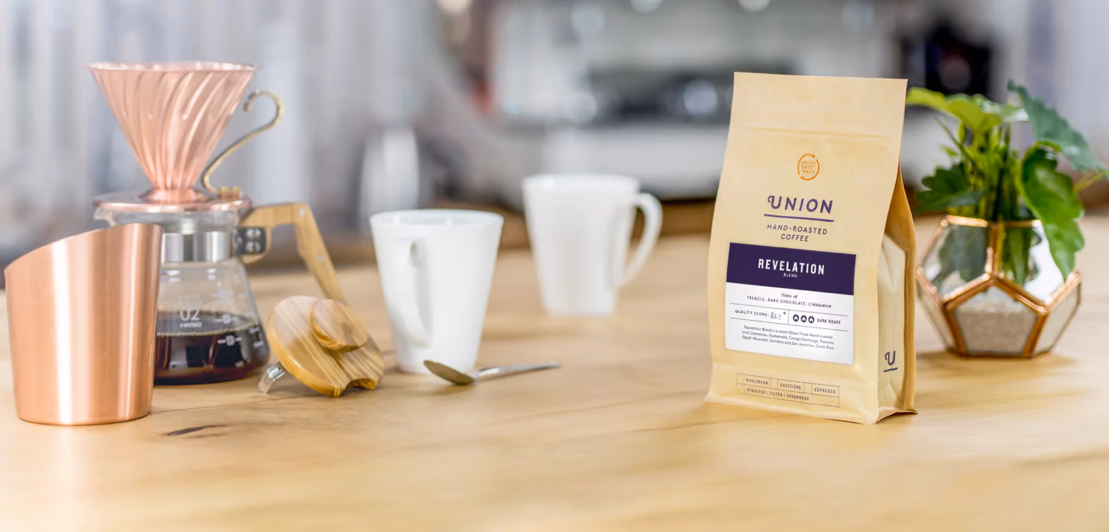 Person holding a package and a flyer of Union hand-roasted House Roast coffee.