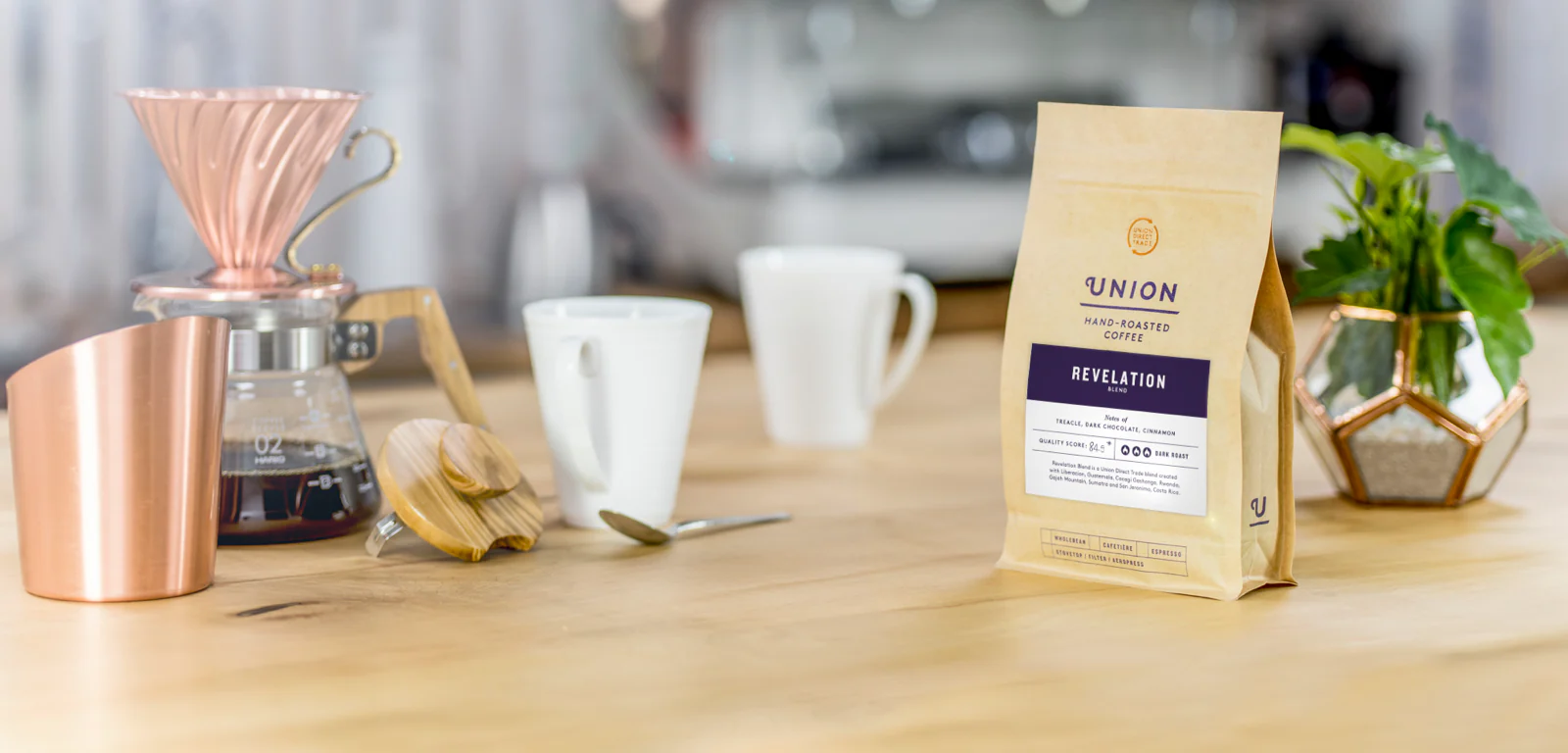 Person holding a package and a flyer of Union hand-roasted House Roast coffee.