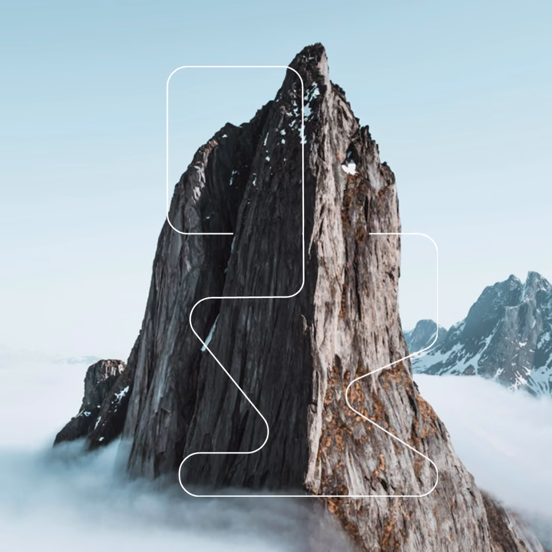 Steep rock spire rising above a sea of clouds