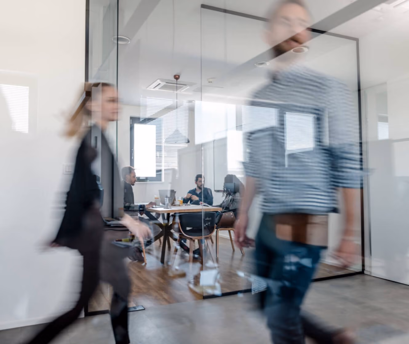 Employees moving through a bright open-plan office