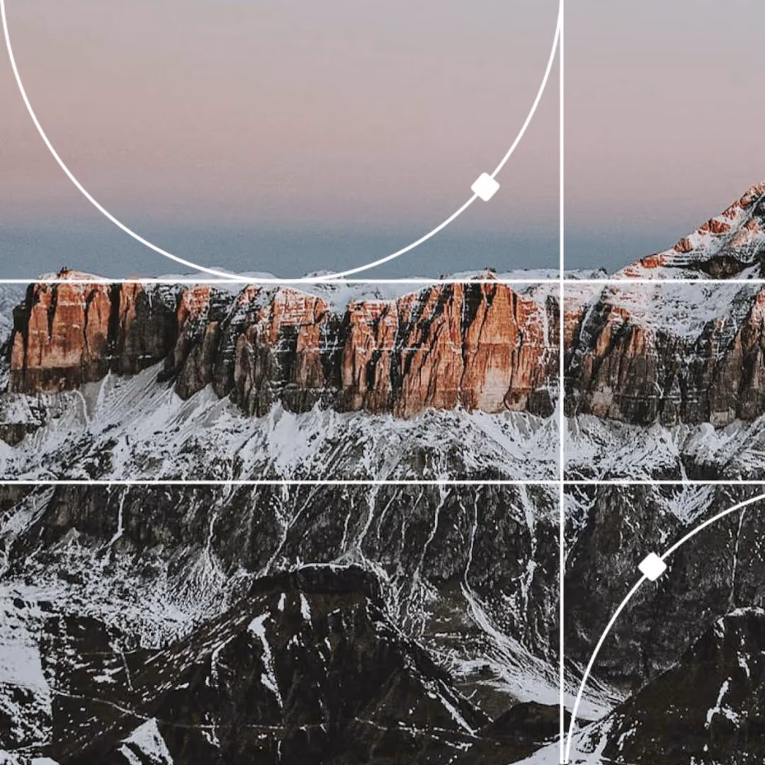 Snow-covered mountain cliff face at dusk