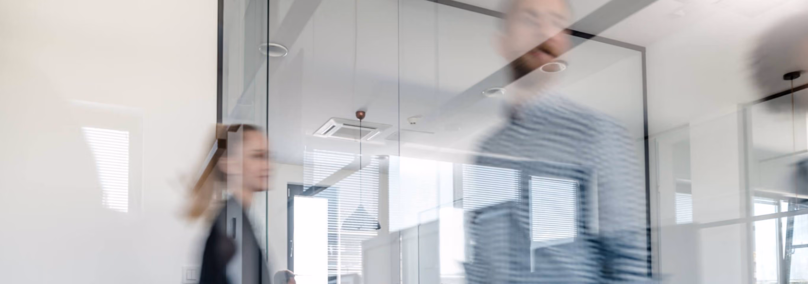 Employee walking through a glass-walled office