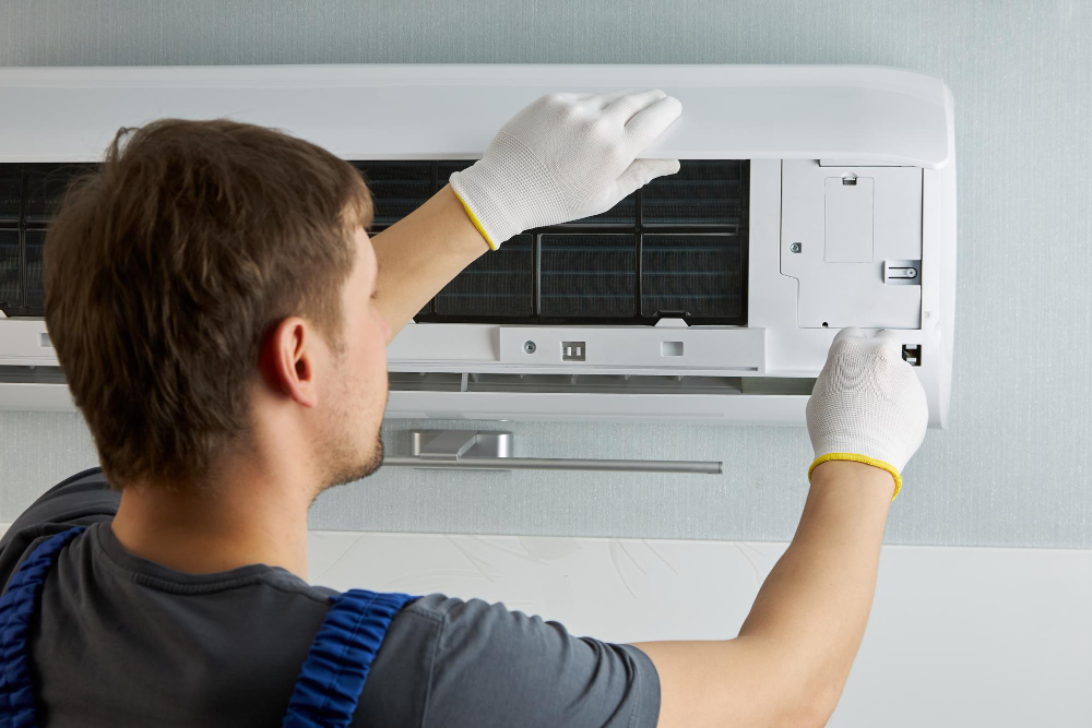 Technician performing an AC tune-up on a residential air conditioning unit