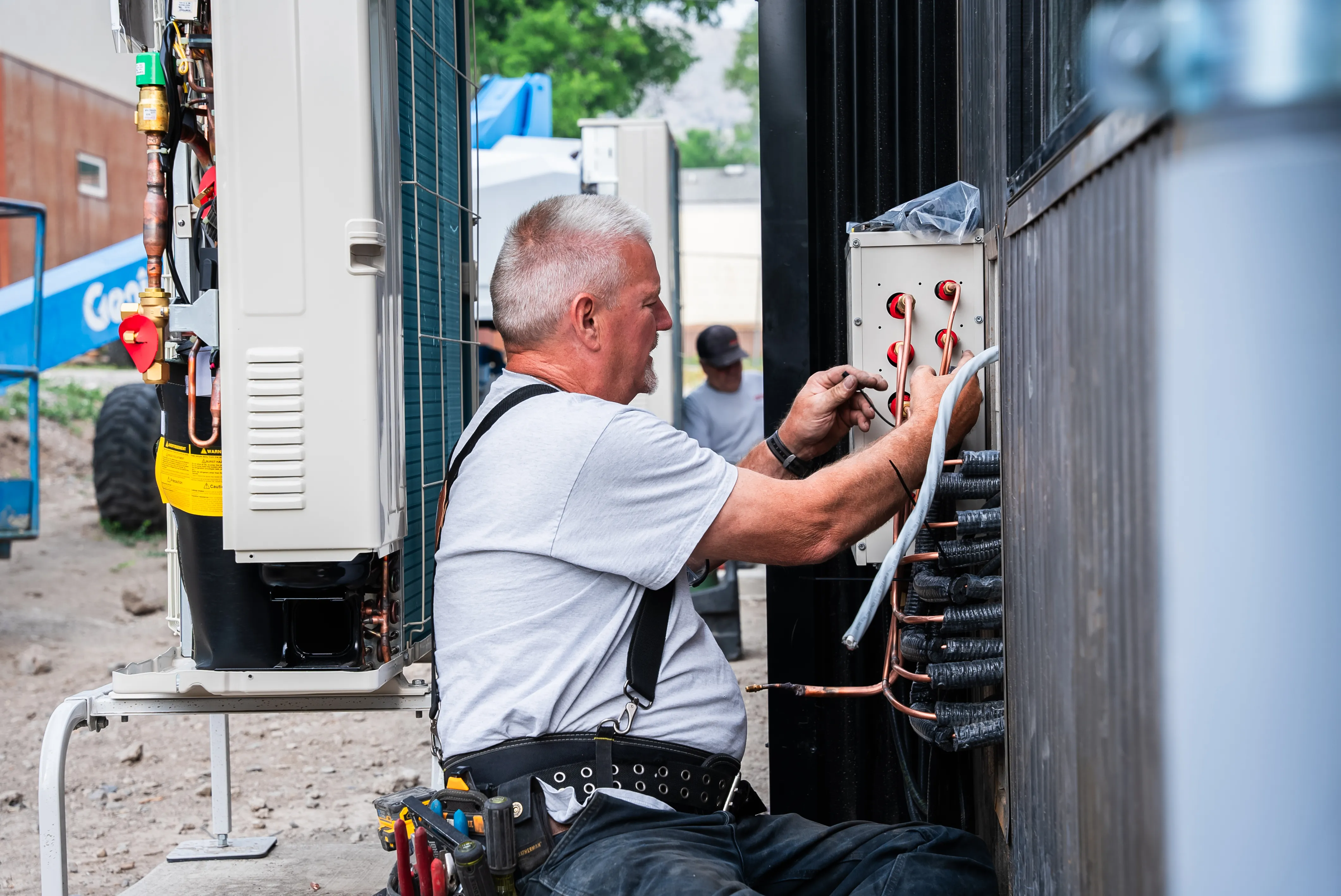 Technician installing residential heating and cooling equipment