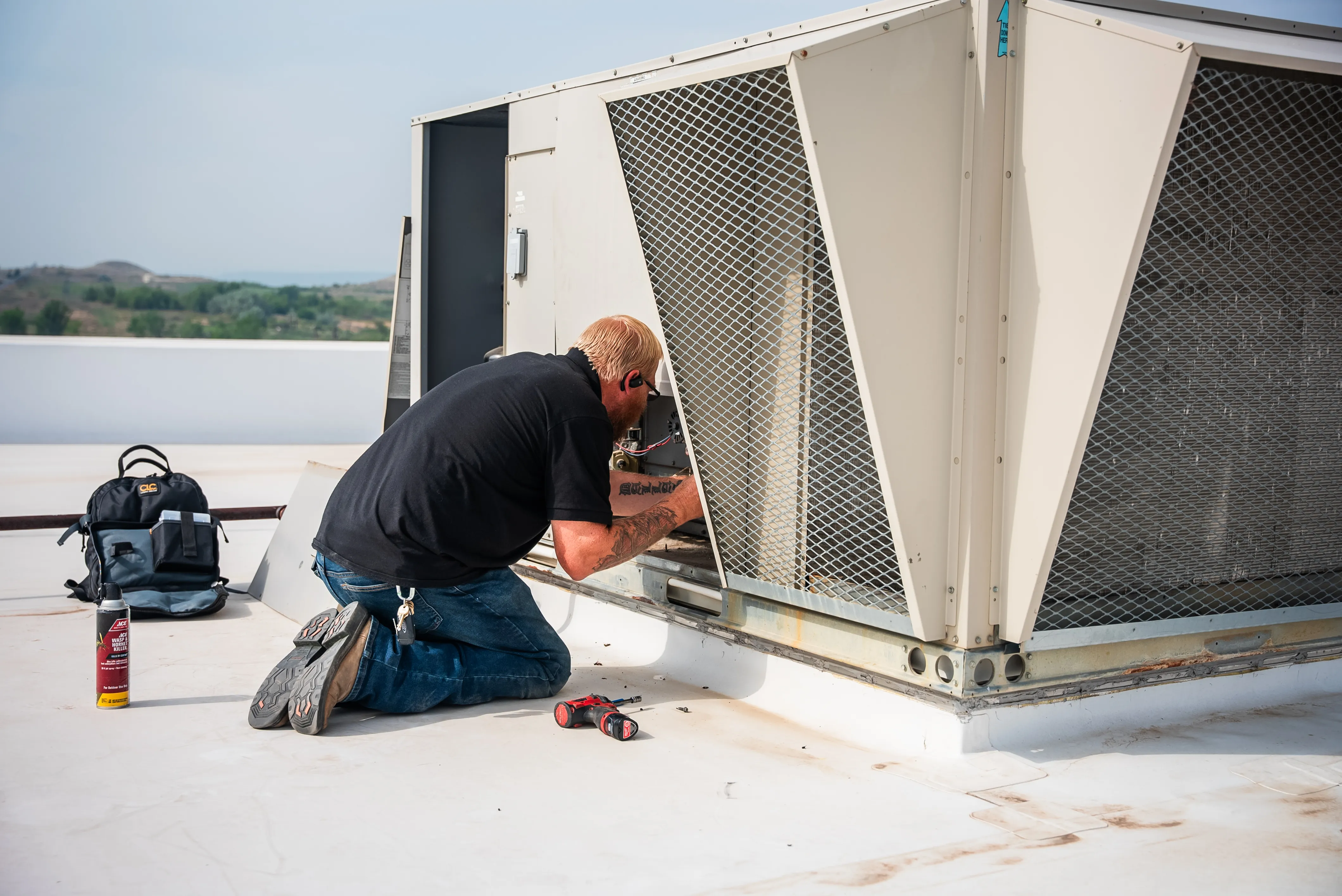 Technician installing residential heating and cooling equipment
