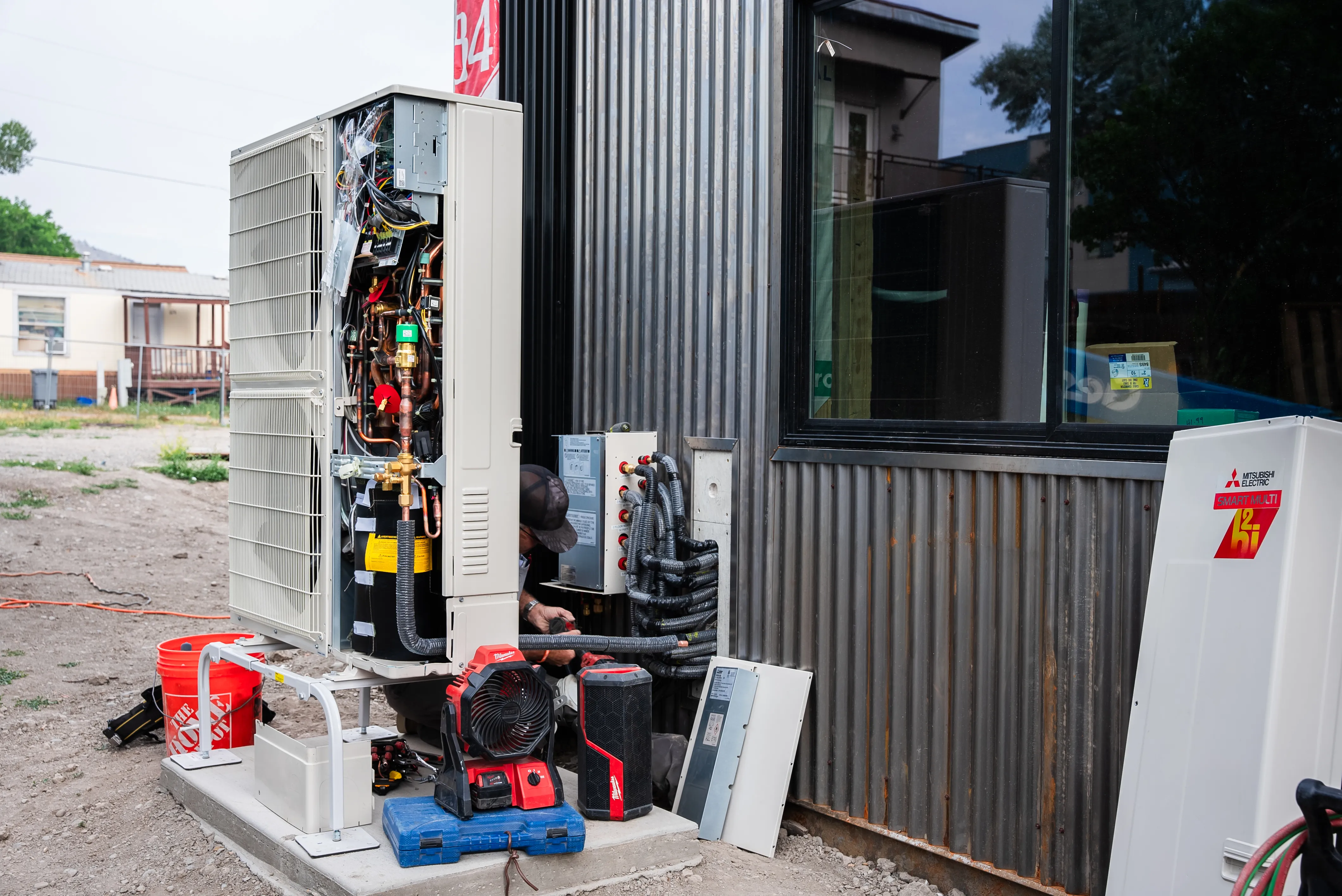 Technician installing residential heating and cooling equipment