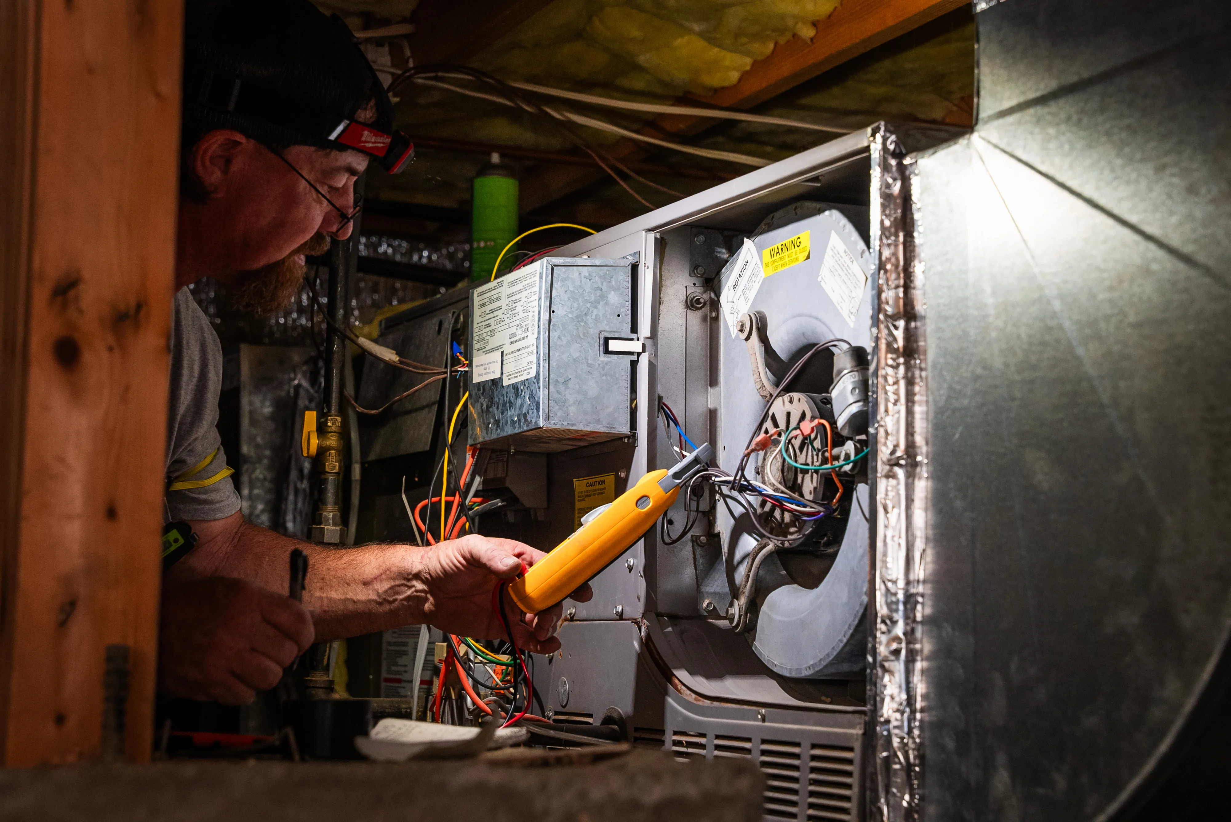 Snipps Heating & Air Conditioning technician servicing HVAC equipment