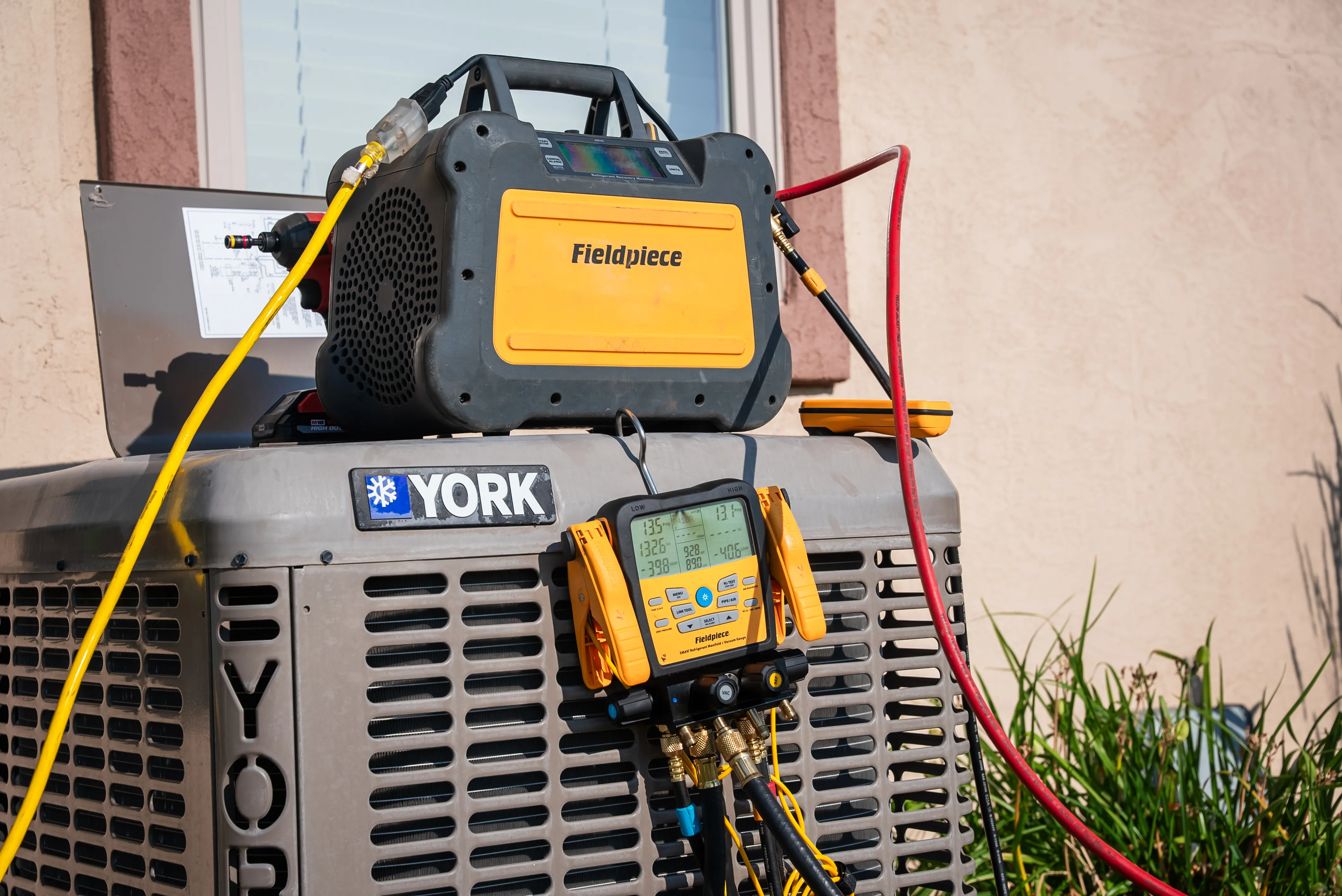 Technician installing residential heating and cooling equipment