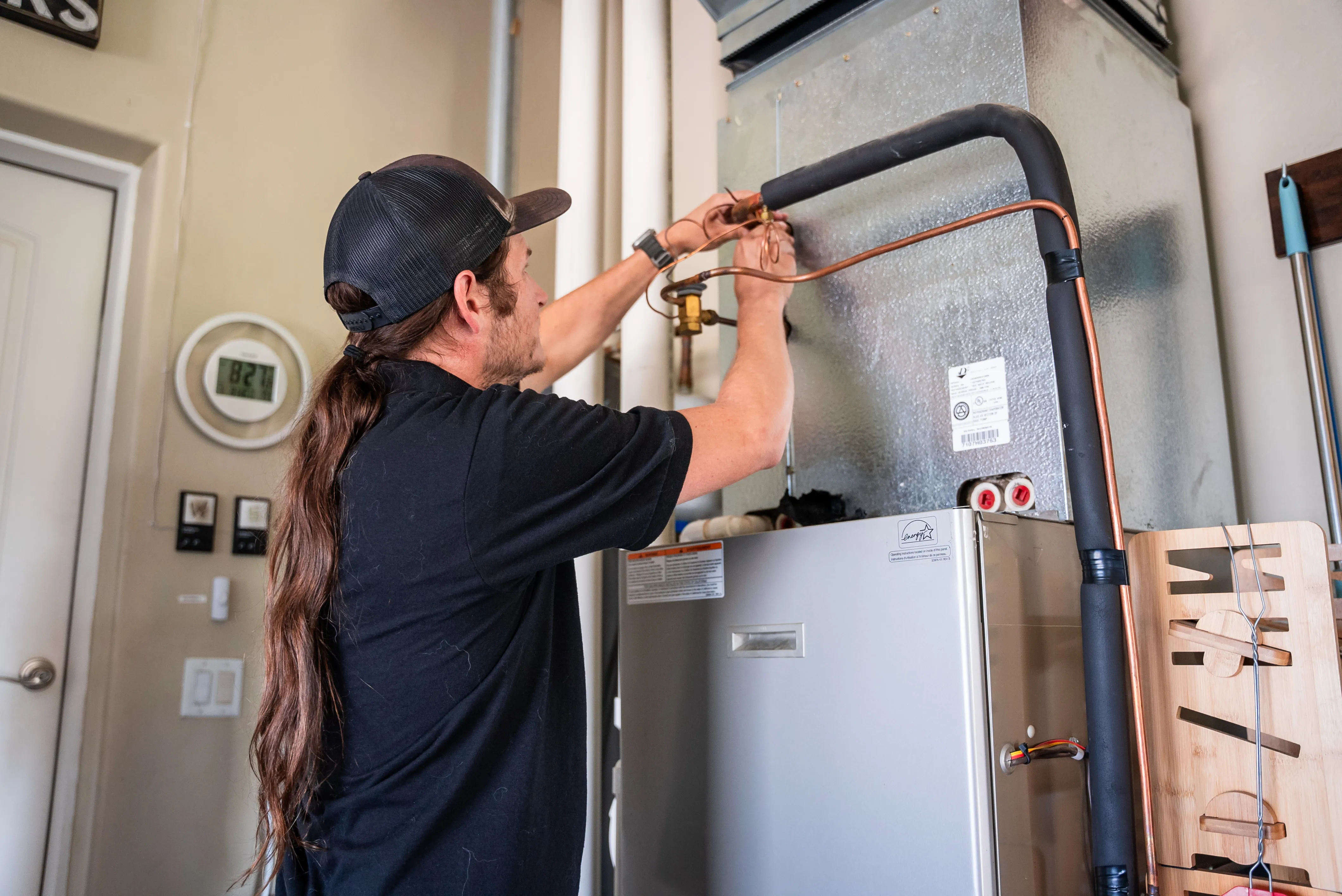 HVAC technician inspecting a furnace or heating system