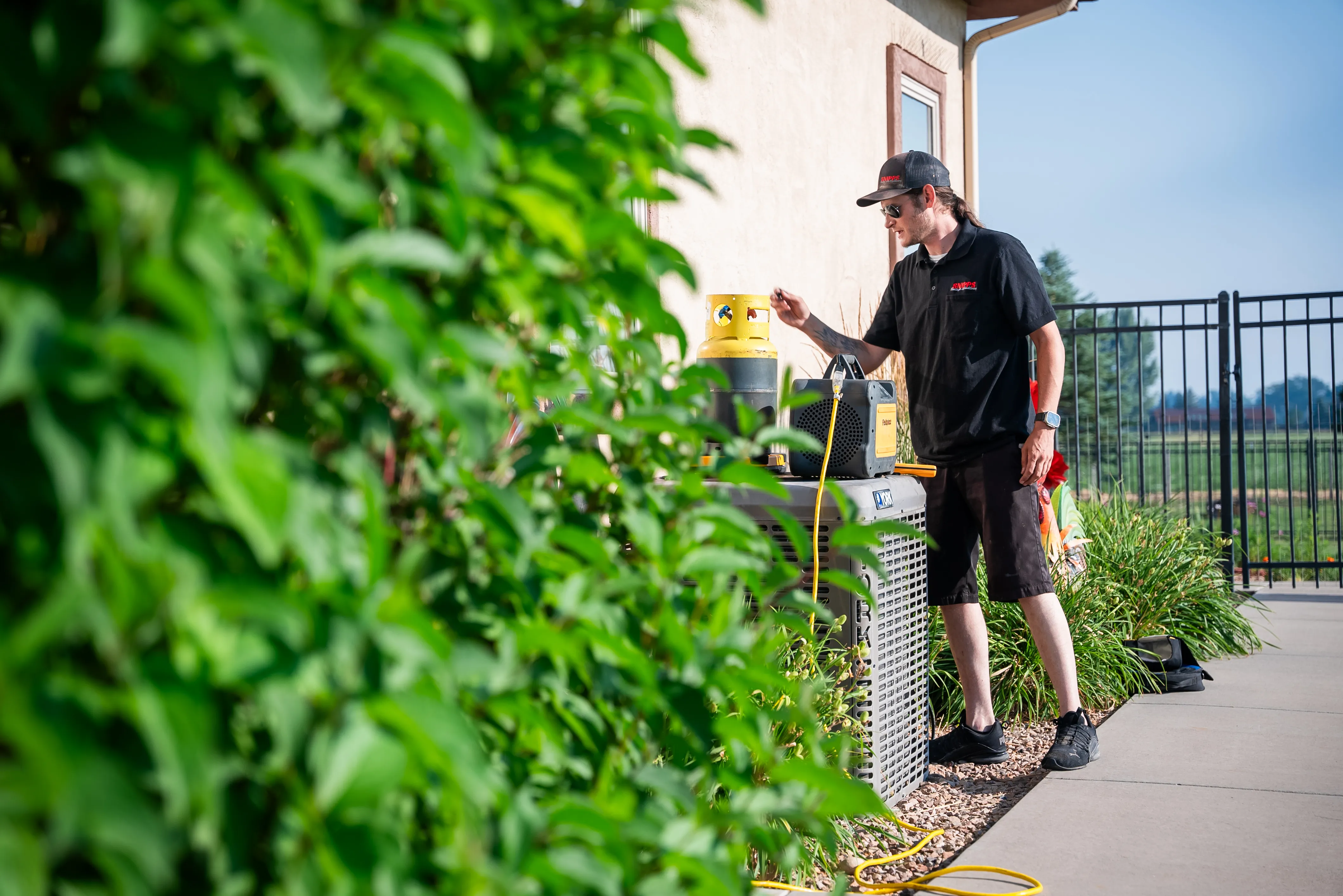 Snipps Heating & Air Conditioning technician servicing HVAC equipment