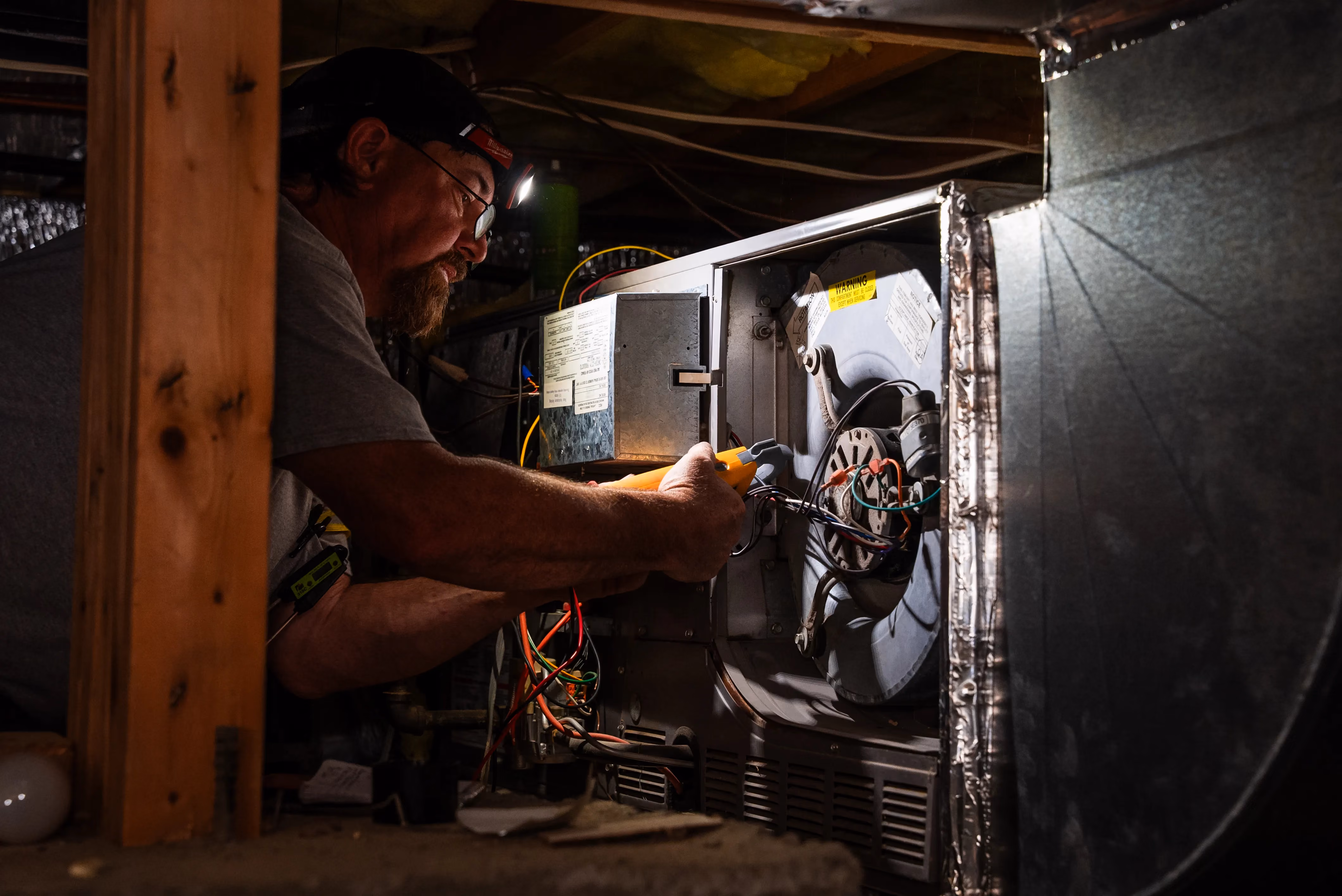 Snipps Heating & Air Conditioning technician servicing HVAC equipment