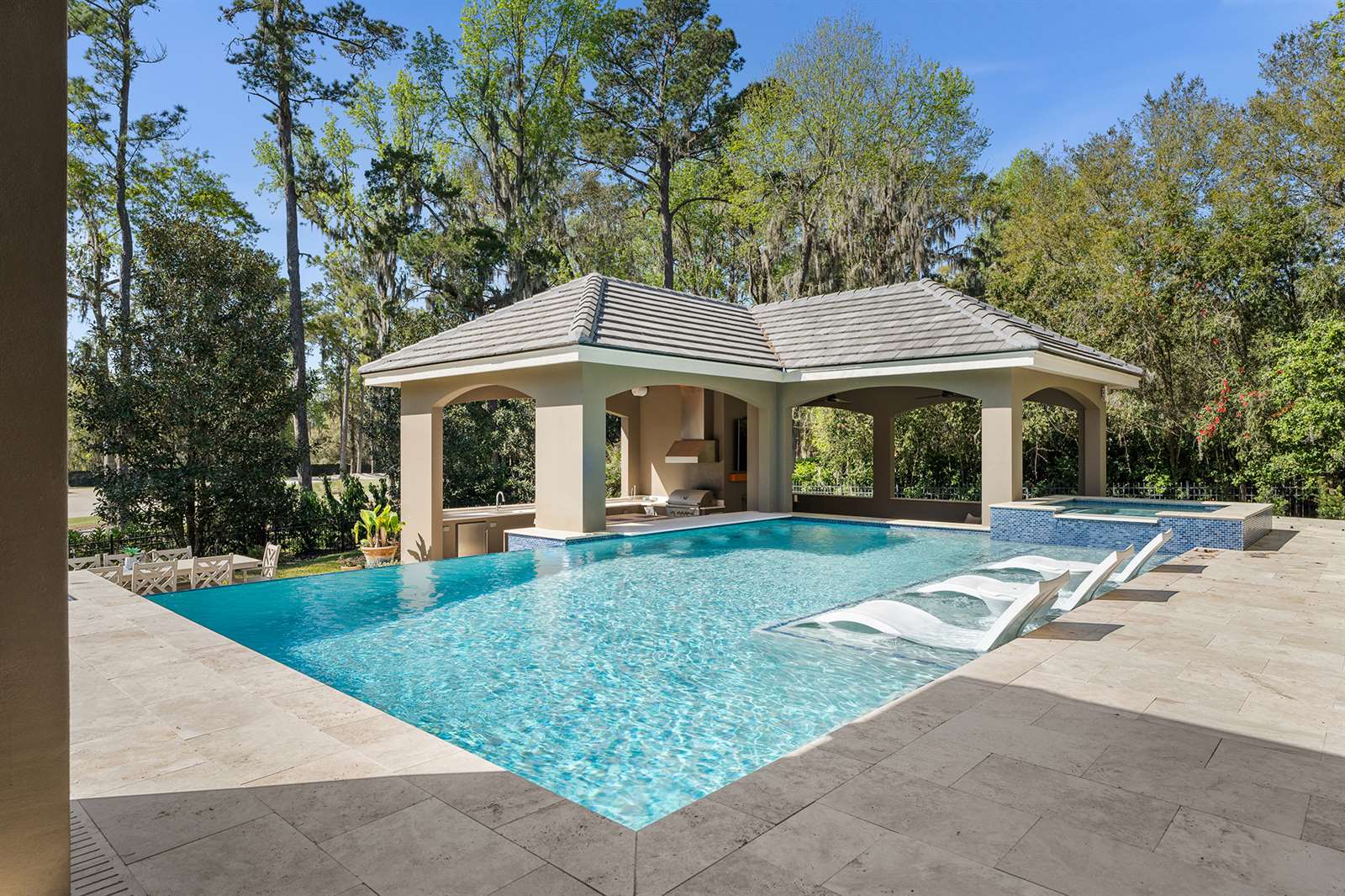 Pool with a tanning ledge at a Spring Hill, Florida home