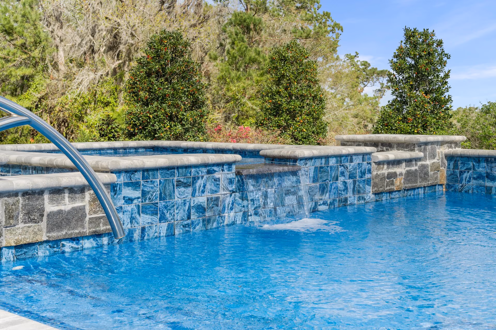Residential pool with arcing deck water jets