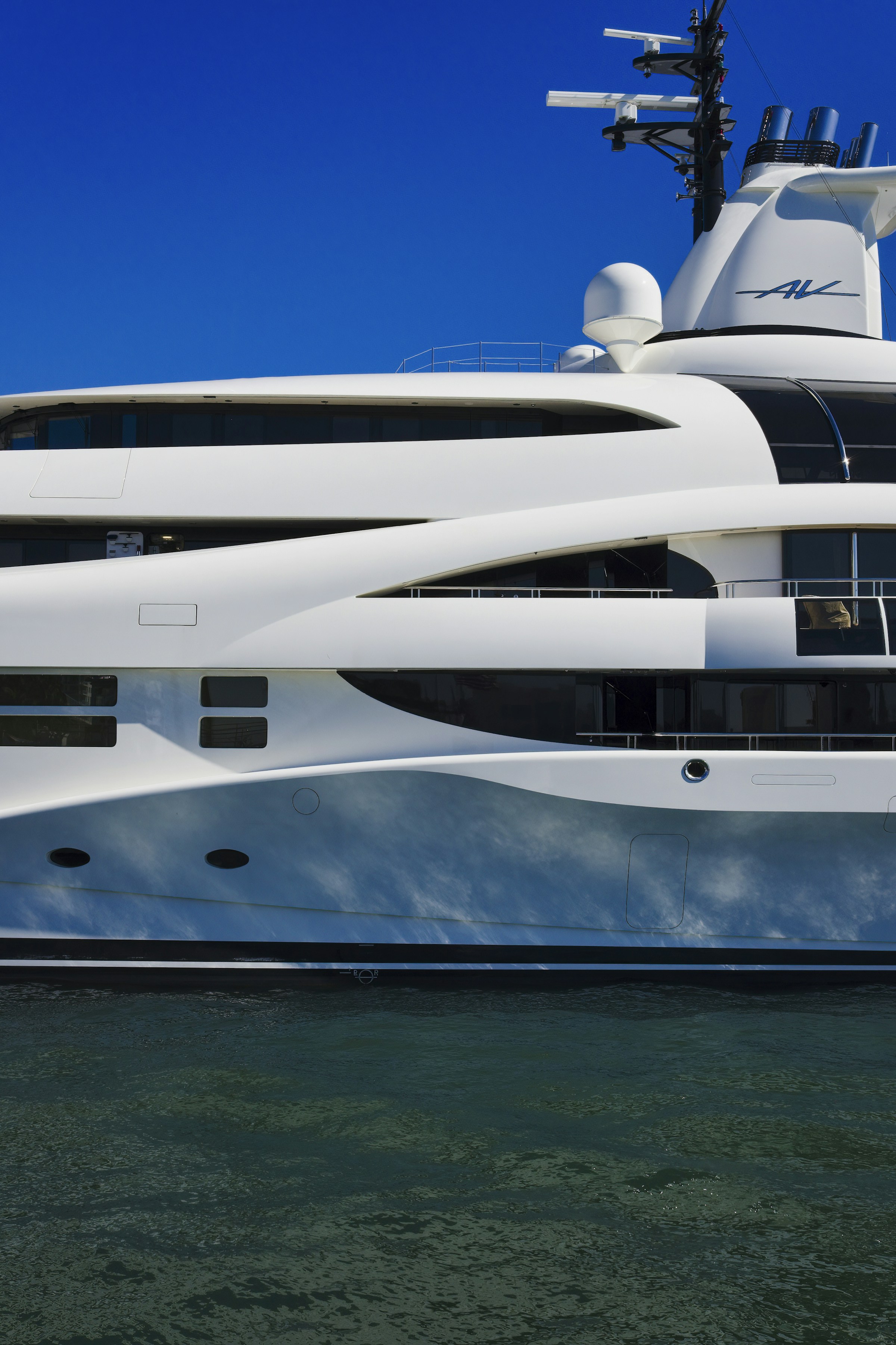 A large white motor yacht on flat blue water off Fort Lauderdale