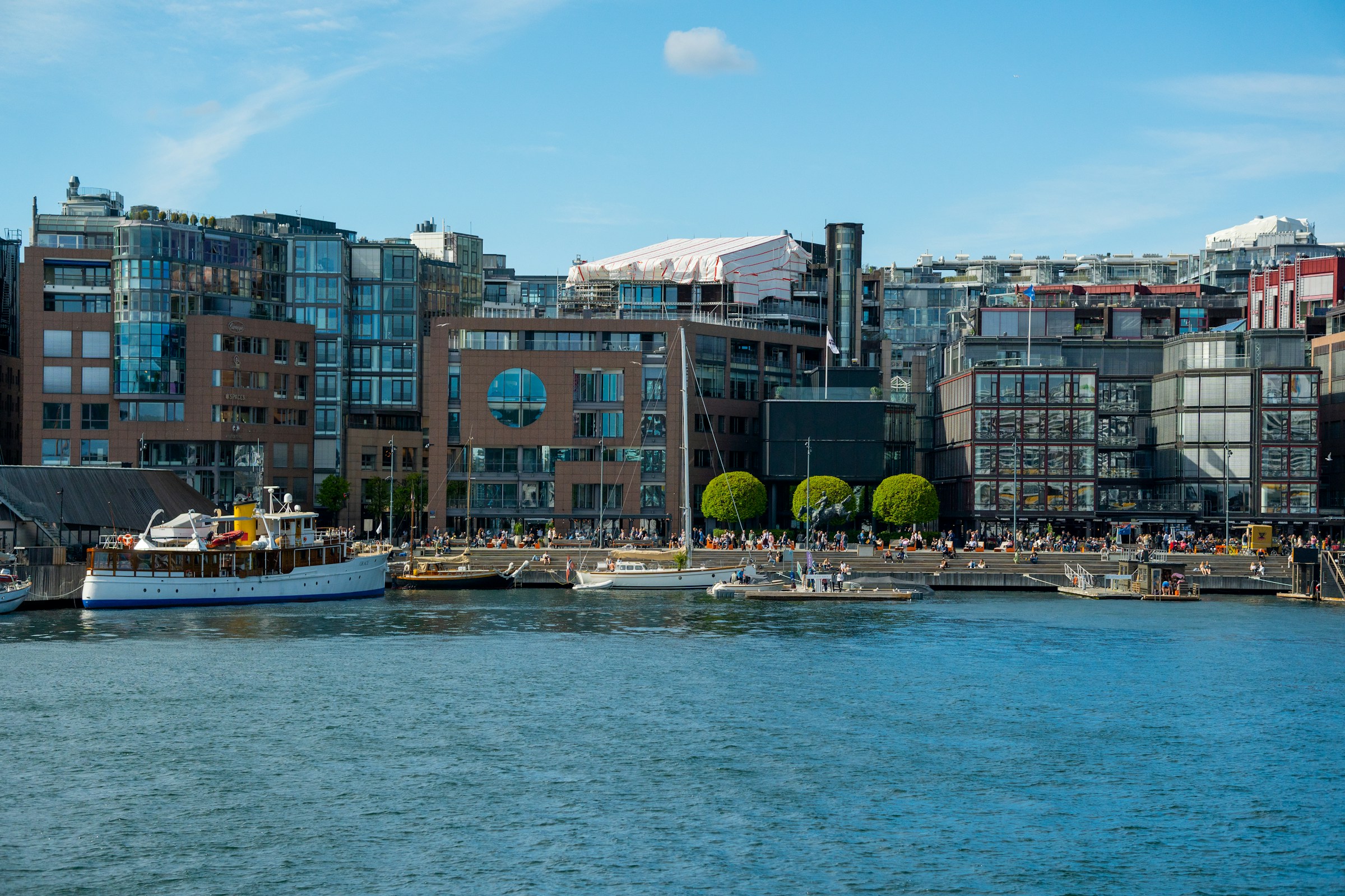 Oslo's Aker Brygge harbour with ferries and moored boats along the waterfront