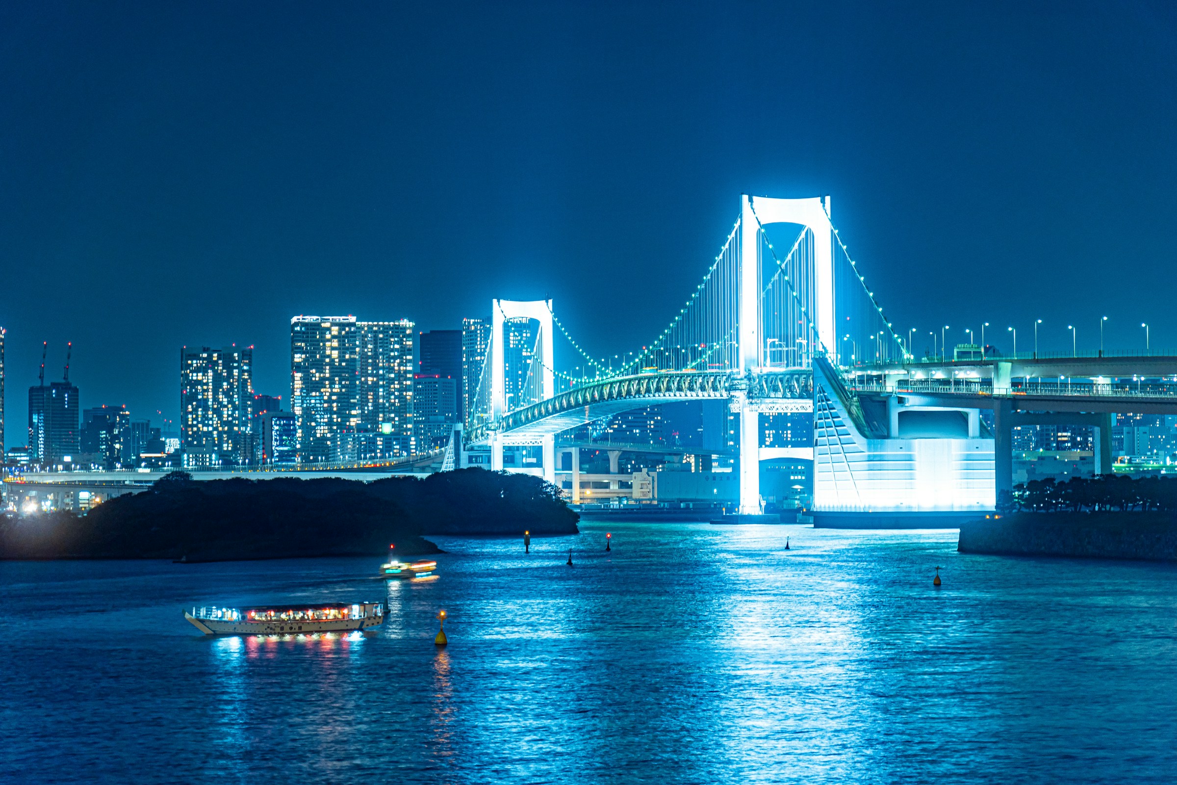 The Rainbow Bridge spanning Tokyo Bay with the city skyline behind