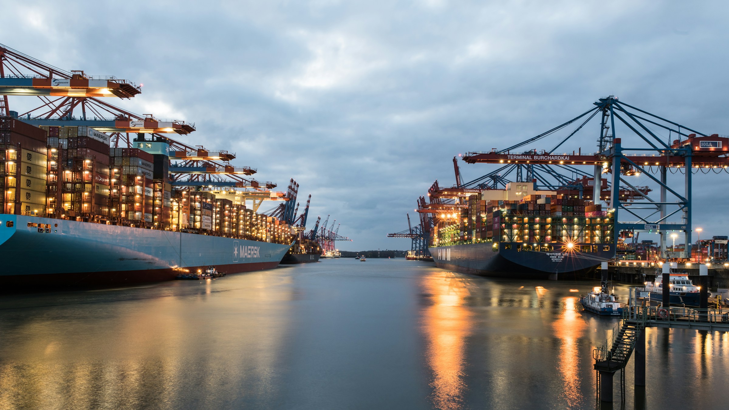 The Port of Hamburg with several large ships berthed along the Elbe