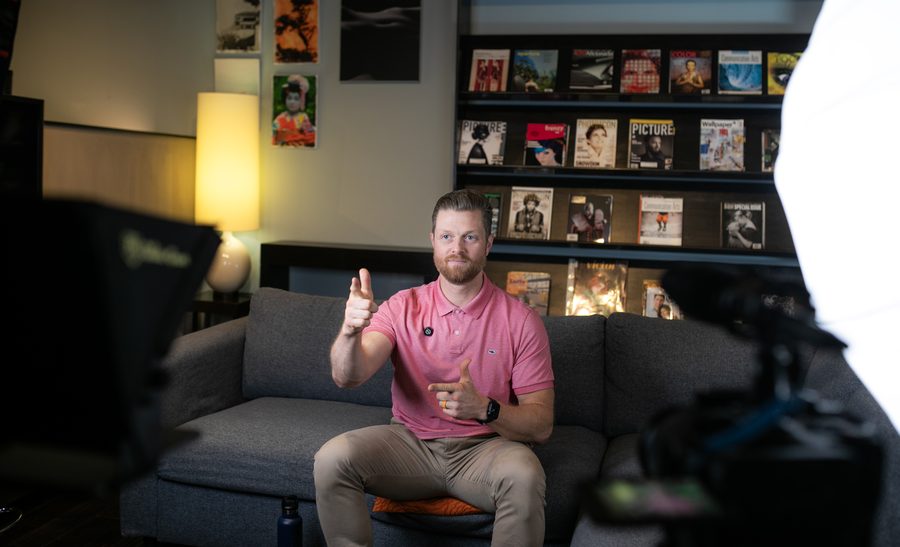 An on-set production photo of a crew filming an interview.