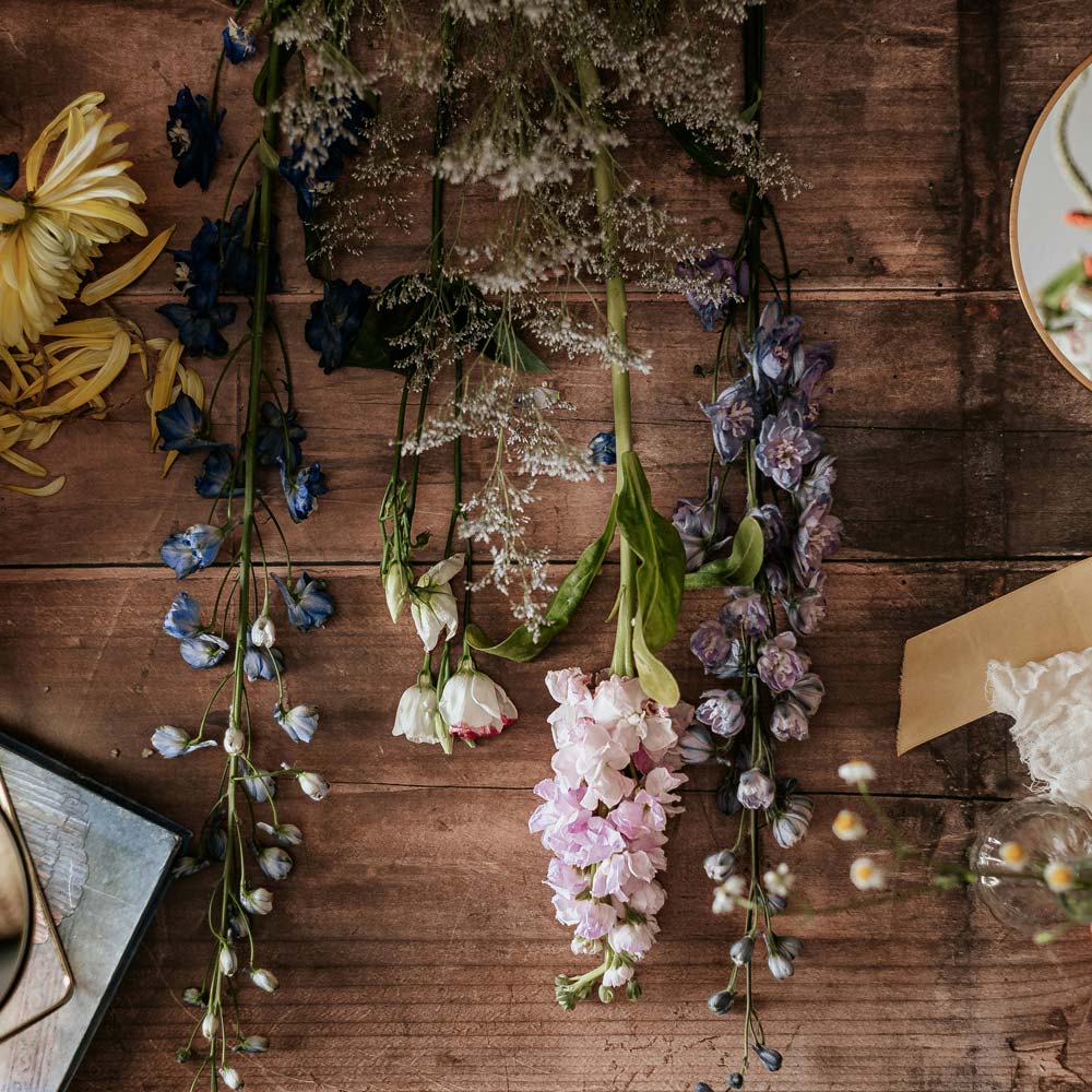 Flowers laid out on a wooden bench