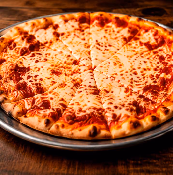 A round cheese pizza sliced into eight pieces on a metal tray over a wooden table.